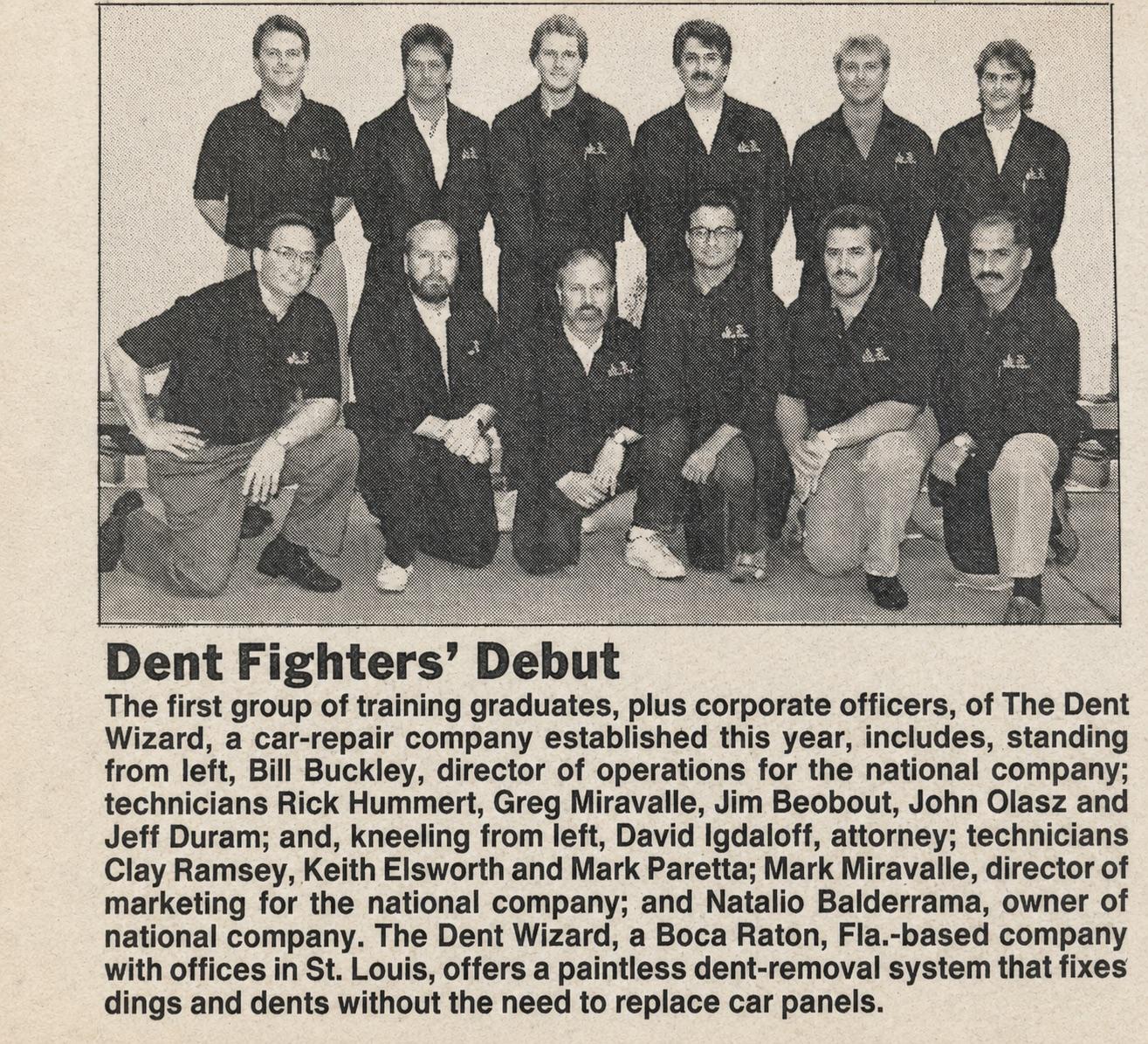 Newspaper clipping headlined Dent Fighters Debut, featuring a group photo of the first U.S. training class of paintless dent repair technicians at The Dent Wizard, including Rick Hummert